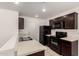 Well-equipped kitchen featuring ample counter space and dark brown cabinets at 8577 S 253Rd Dr, Buckeye, AZ 85326