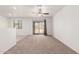 Spacious living room with ceiling fan and sliding glass doors leading to the backyard at 8577 S 253Rd Dr, Buckeye, AZ 85326