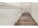 Carpeted staircase in a well lit entry hall at 8577 S 253Rd Dr, Buckeye, AZ 85326
