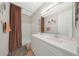 Well-lit bathroom featuring a double sink vanity and shower-tub combination for modern convenience at 8683 S 165Th Ave, Goodyear, AZ 85338