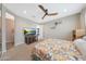 Bedroom featuring a ceiling fan, a TV stand, patterned linens, and neutral walls at 8683 S 165Th Ave, Goodyear, AZ 85338