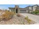 Charming house with a paved driveway, desert landscaping, and attached two-car garage at 8683 S 165Th Ave, Goodyear, AZ 85338
