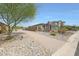Landscaped home with desert landscaping and a beautiful stone and siding facade at 8683 S 165Th Ave, Goodyear, AZ 85338