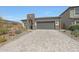 Beautiful home featuring stone accents, a brick driveway, and a two-car garage at 8683 S 165Th Ave, Goodyear, AZ 85338