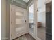 Inviting foyer with tile floors and a view of the office through glass doors at 8683 S 165Th Ave, Goodyear, AZ 85338