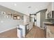 Bright kitchen featuring stainless steel appliances, a granite countertop island, and wood-look tile flooring at 8683 S 165Th Ave, Goodyear, AZ 85338