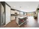Open-concept kitchen with stainless steel appliances and a granite countertop island overlooking the living area at 8683 S 165Th Ave, Goodyear, AZ 85338