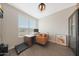 A bright and sunny home office featuring wood floors, ample natural light, and tasteful decor at 8683 S 165Th Ave, Goodyear, AZ 85338