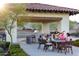 Outdoor kitchen and seating area, ideal for community gatherings and outdoor entertaining at 8683 S 165Th Ave, Goodyear, AZ 85338