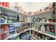 Organized pantry shelving, perfect for ample food and kitchen storage in this home at 8683 S 165Th Ave, Goodyear, AZ 85338