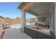Covered patio with outdoor seating and a view of the pool, ideal for entertaining and relaxation at 8683 S 165Th Ave, Goodyear, AZ 85338