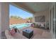 Stylish covered patio with comfortable seating, pool view, and outdoor entertainment options, perfect for gatherings at 8683 S 165Th Ave, Goodyear, AZ 85338