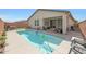 Relaxing backyard pool with patio and outdoor seating offers a perfect retreat at 8683 S 165Th Ave, Goodyear, AZ 85338