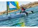 A person sailing on the lake with mountain views, enjoying recreational boating activities at 8683 S 165Th Ave, Goodyear, AZ 85338