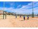 Active beach volleyball game with mountain views, showcasing the outdoor recreational amenities at 8683 S 165Th Ave, Goodyear, AZ 85338