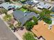 Aerial view of a home with lush landscaping, inground pool and outdoor lounging at 8732 E Sandalwood Dr, Scottsdale, AZ 85250