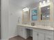 Bathroom featuring double sinks, white cabinets, neutral countertops, and framed mirrors at 8732 E Sandalwood Dr, Scottsdale, AZ 85250