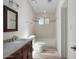 Bright bathroom boasts a wood vanity, granite counters, decorative mirror, and shower-tub combo at 8732 E Sandalwood Dr, Scottsdale, AZ 85250