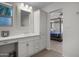 Bright bathroom features a single sink, modern vanity and provides access to the primary bedroom at 8732 E Sandalwood Dr, Scottsdale, AZ 85250