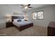 This bedroom has neutral walls, bedside lamps and tables, a ceiling fan, and a window at 8732 E Sandalwood Dr, Scottsdale, AZ 85250