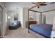 Serene bedroom with a canopy bed, soft carpeting, and a cozy chaise lounge seating area at 8732 E Sandalwood Dr, Scottsdale, AZ 85250
