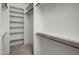 Walk-in closet has built-in shelves to keep clothes and other items organized at 8732 E Sandalwood Dr, Scottsdale, AZ 85250