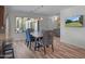 Bright dining area with modern lighting, views of the backyard, and seamless transition to the kitchen at 8732 E Sandalwood Dr, Scottsdale, AZ 85250