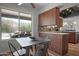 Eat-in kitchen with wood cabinets, stainless appliances and view of the outdoor patio and pool at 8732 E Sandalwood Dr, Scottsdale, AZ 85250