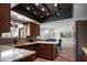 Modern kitchen featuring stainless steel appliances, granite countertops, and wood cabinets at 8732 E Sandalwood Dr, Scottsdale, AZ 85250