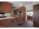 Eat-in kitchen includes stainless appliances, dark wood cabinetry and view into adjacent living space at 8732 E Sandalwood Dr, Scottsdale, AZ 85250