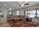 Spacious living room with a large sectional couch, patterned rug, and ample natural light from the large window at 8732 E Sandalwood Dr, Scottsdale, AZ 85250