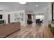 Open-concept living space features wood-look floors, modern decor, and seamless flow to dining and kitchen at 8732 E Sandalwood Dr, Scottsdale, AZ 85250