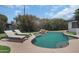 Inviting pool with stone waterfall feature and artificial turf at 8732 E Sandalwood Dr, Scottsdale, AZ 85250