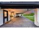 Inviting covered back patio with brick pavers, sliding door access, seating, and pet door under a colorful sky at 9005 W Villa Chula St, Peoria, AZ 85383
