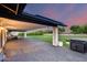 Spacious covered patio and backyard featuring lush green grass and an outdoor kitchen at 9005 W Villa Chula St, Peoria, AZ 85383
