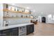 Stylish bar with custom shelving, sleek cabinetry, quartz countertops, and a mini-refrigerator at 9005 W Villa Chula St, Peoria, AZ 85383