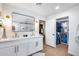 Bright bathroom with double vanity, sleek mirror, and stylish closet with organized storage at 9005 W Villa Chula St, Peoria, AZ 85383