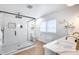 Bright bathroom features a glass-enclosed shower, and marble countertops, showcasing luxury design at 9005 W Villa Chula St, Peoria, AZ 85383