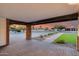A covered entrance with desert landscaping and pavers offers an appealing invitation to the home at 9005 W Villa Chula St, Peoria, AZ 85383