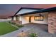 Inviting covered parking, desert landscaping and brick accents adorn the front of this home at 9005 W Villa Chula St, Peoria, AZ 85383