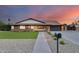 Charming single-story home with brick accents, manicured landscaping, and lush, green grass at 9005 W Villa Chula St, Peoria, AZ 85383