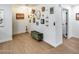 Bright hallway with wood floors, decorative wall art, and a bench at 9005 W Villa Chula St, Peoria, AZ 85383