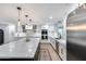 Spacious kitchen with a large island, stainless steel refrigerator, modern appliances, and bright lighting at 9005 W Villa Chula St, Peoria, AZ 85383
