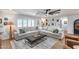 Spacious living area with a cozy sectional sofa, decorative pillows, and an ottoman coffee table at 9005 W Villa Chula St, Peoria, AZ 85383