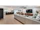 Open-concept living room flows into a kitchen with an island, stainless appliances, and dining area at 9005 W Villa Chula St, Peoria, AZ 85383