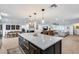 Open-concept living area featuring a kitchen island, dining area, and comfortable lounge space at 9005 W Villa Chula St, Peoria, AZ 85383