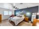 Serene main bedroom boasts a decorative accent wall, wood furniture, and ample natural light at 9005 W Villa Chula St, Peoria, AZ 85383
