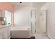 Bright bathroom featuring a soaking tub and a glass enclosed shower at 10723 N 118Th Way, Scottsdale, AZ 85259
