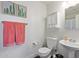 Small, well lit bathroom featuring a pedestal sink, and toilet at 10723 N 118Th Way, Scottsdale, AZ 85259