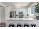 Bright kitchen featuring blue cabinets, stainless appliances, a breakfast bar, and modern lighting fixtures at 10723 N 118Th Way, Scottsdale, AZ 85259